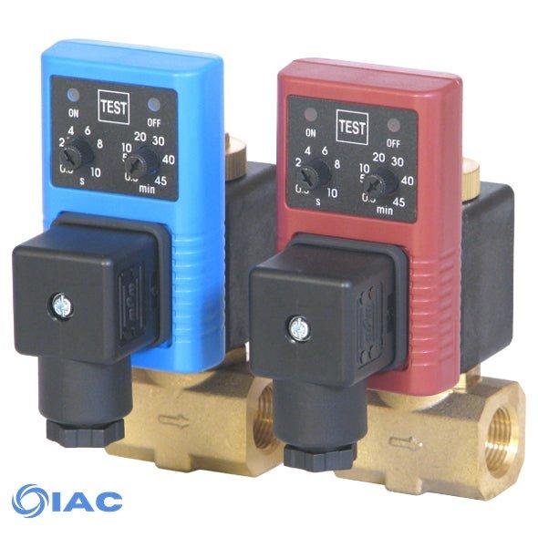 Two IAC timer solenoid valves, one blue and one red, mounted on brass manifolds against a white background.