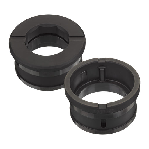 Two black rubber bushings on a white background