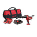 Milwaukee tool set with caulking gun, battery, charger, and bag on a white background