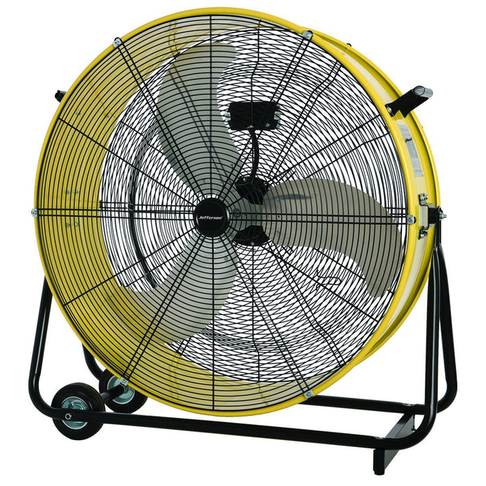 A large industrial floor fan with a bright yellow protective cage, black metal fan blades, and a black wheeled stand, shown against a plain white background.