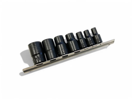 Set of black sockets on a metallic tray against a white background