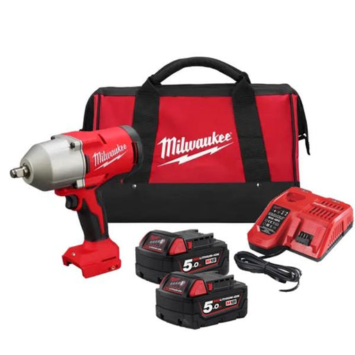 Milwaukee power tool kit with impact wrench, batteries, charger, and carrying bag on a white background