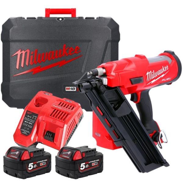 Milwaukee power tool set with nail gun, batteries, and case on a white background